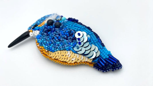 Handmade beaded brooch in the shape of a kingfisher made from glass beads, sequins, bugle beads and rhinestones