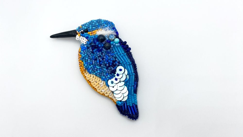 Handmade beaded brooch in the shape of a kingfisher made from glass beads, sequins, bugle beads and rhinestones