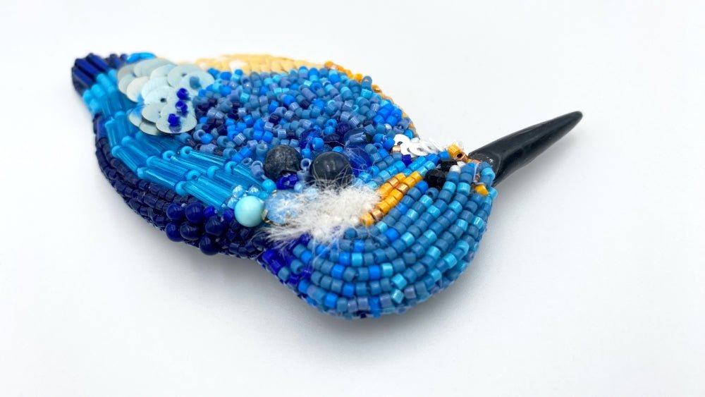 Handmade beaded brooch in the shape of a kingfisher made from glass beads, sequins, bugle beads and rhinestones