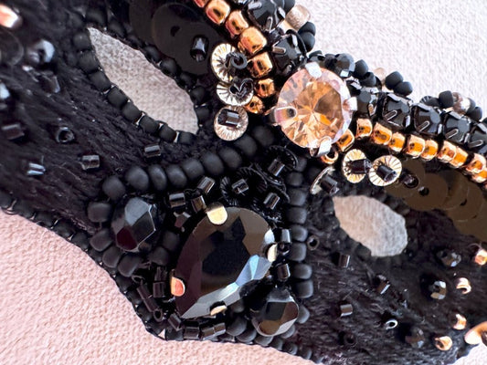 Handmade brooch in the shape of a Venetian masquerade mask crafted in black and gold from beads, sequins, rhinestones and embroidery - Ornamentico Shop