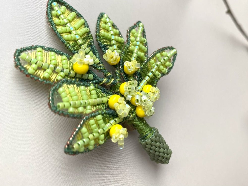 Handmade beaded and embroidered brooch with beaded leaves and yellow mimosa-inspired flowers - Ornamentico shop