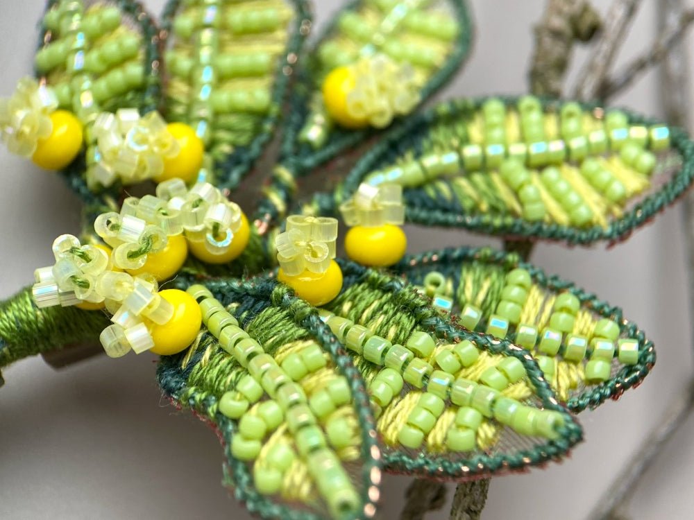 Handmade beaded and embroidered brooch with beaded leaves and yellow mimosa-inspired flowers - Ornamentico shop