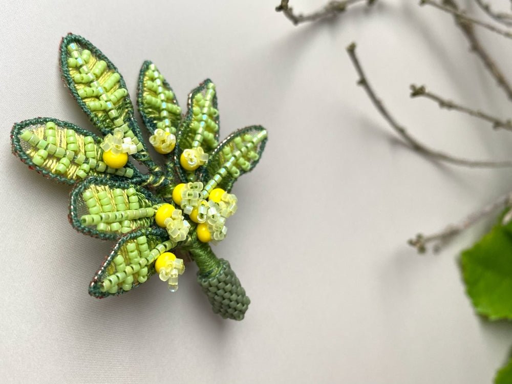 Handmade beaded and embroidered brooch with beaded leaves and yellow mimosa-inspired flowers - Ornamentico shop