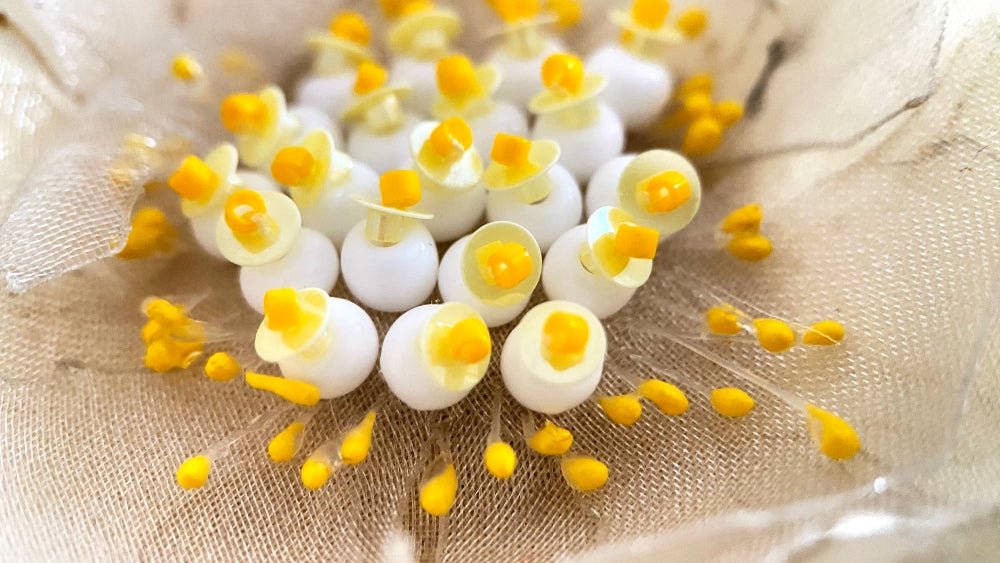 Handmade pale-yellow floral brooch crafted from organza fabric, beads and sequins