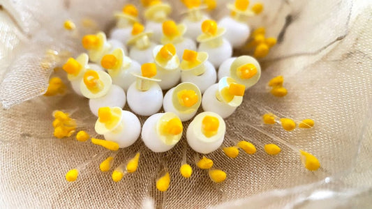 Handmade pale-yellow floral brooch crafted from organza fabric, beads and sequins