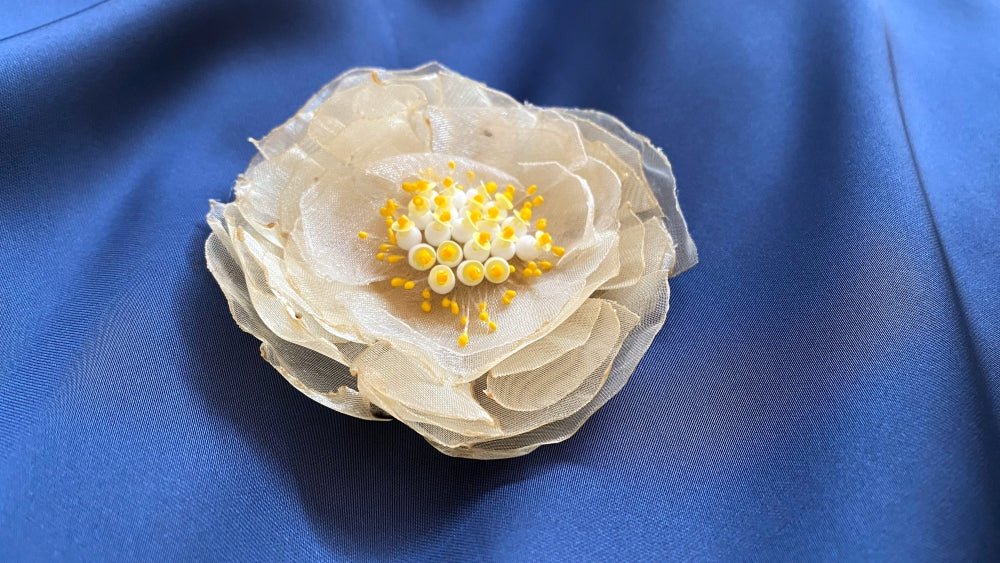 Handmade pale-yellow floral brooch crafted from organza fabric, beads and sequins