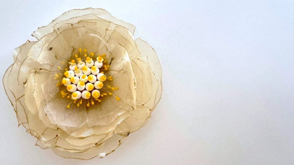 Handmade pale-yellow floral brooch crafted from organza fabric, beads and sequins