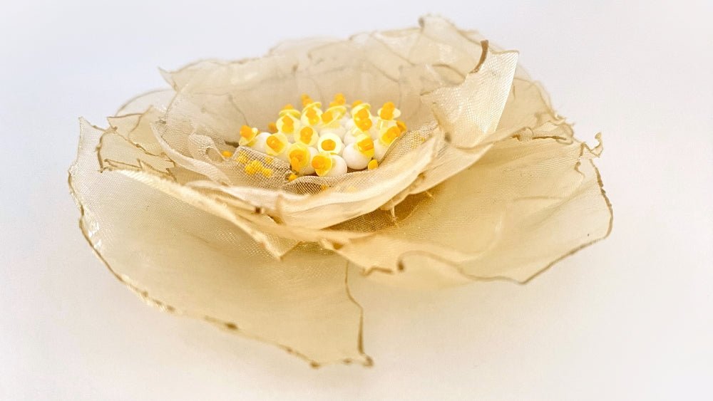 Handmade pale-yellow floral brooch crafted from organza fabric, beads and sequins