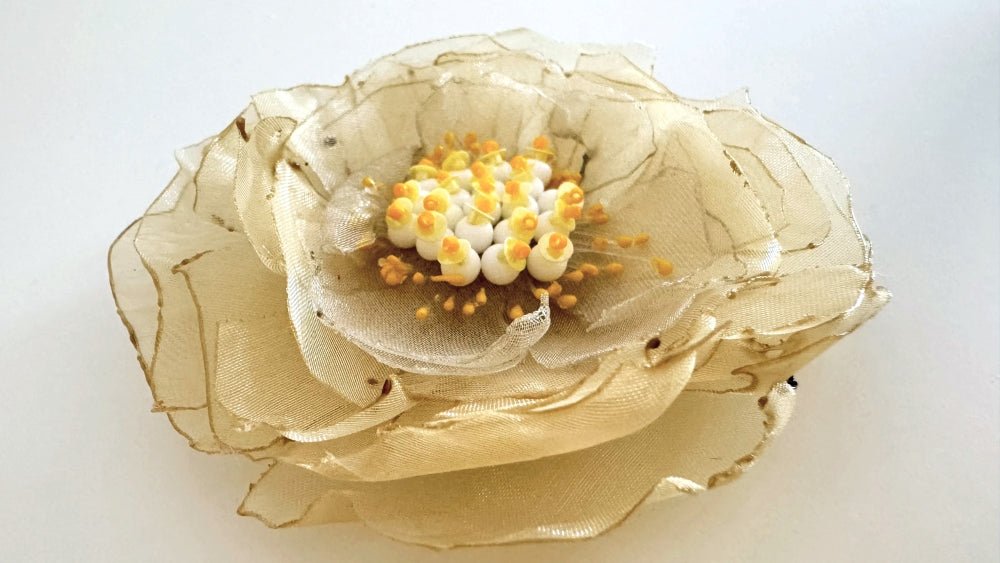 Handmade pale-yellow floral brooch crafted from organza fabric, beads and sequins