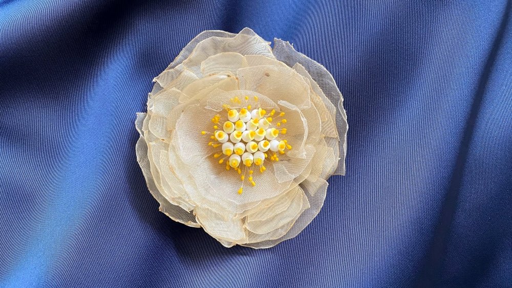 Handmade pale-yellow floral brooch crafted from organza fabric, beads and sequins