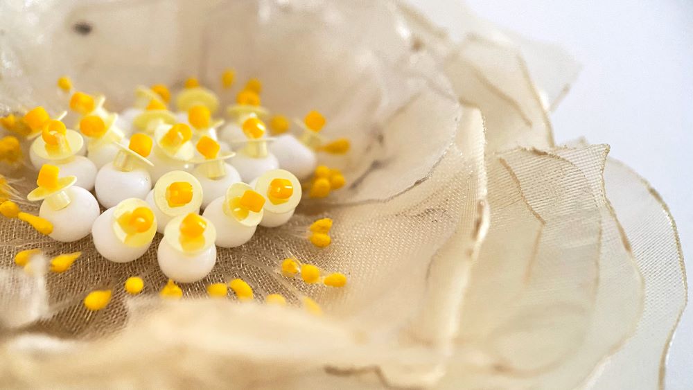 Handmade pale-yellow floral brooch crafted from organza fabric, beads and sequins