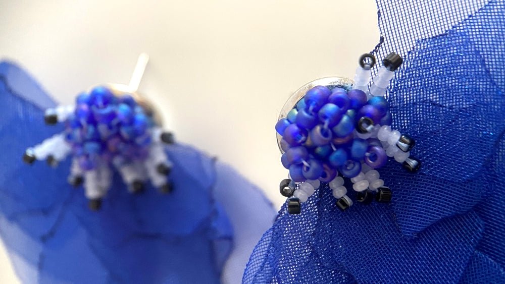 Handmade floral stud earrings in the shape of anemone flowers made from organza fabric and beads