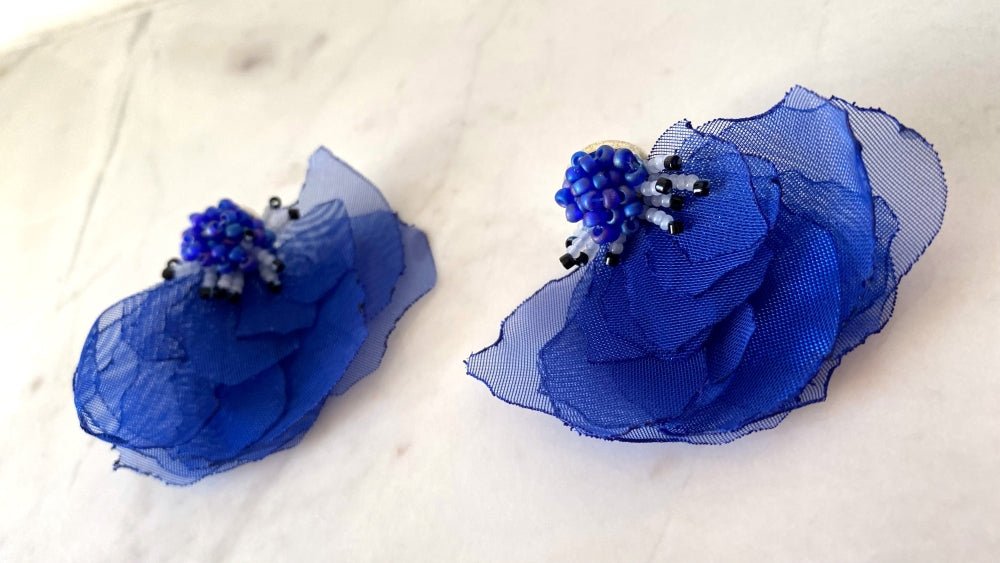 Handmade floral stud earrings in the shape of anemone flowers made from organza fabric and beads