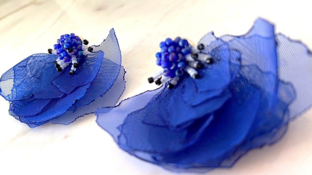 Handmade floral stud earrings in the shape of anemone flowers made from organza fabric and beads