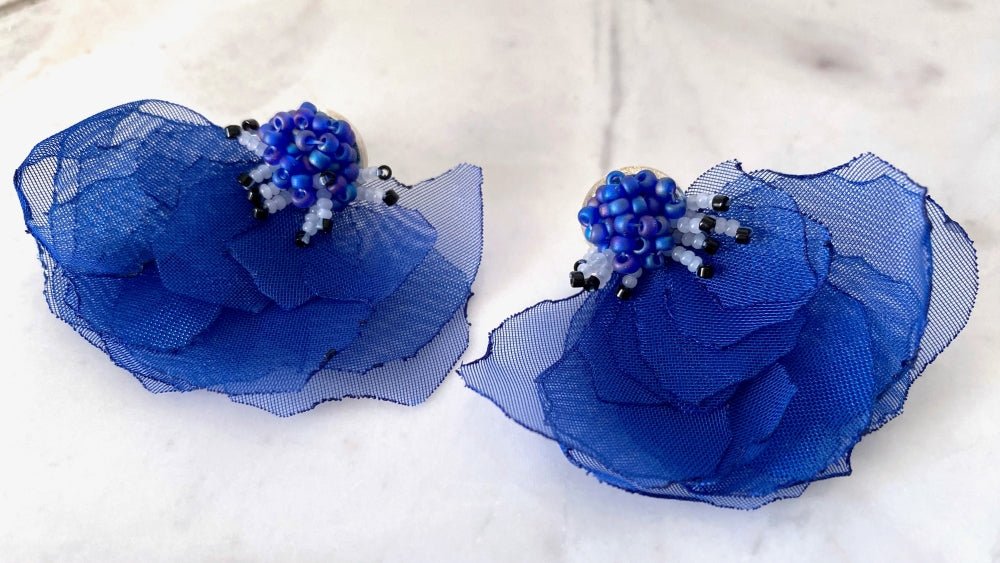 Handmade floral stud earrings in the shape of anemone flowers made from organza fabric and beads
