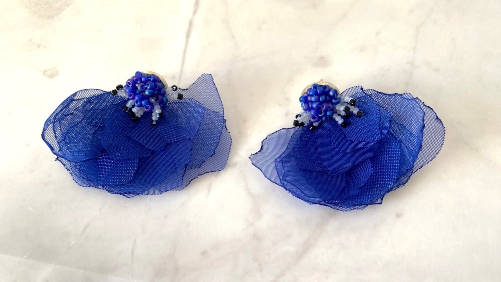 Handmade floral stud earrings in the shape of anemone flowers made from organza fabric and beads