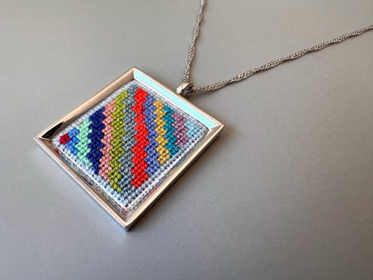 Unique hand embroidered pendant in oriental Peruvian design, set in custom silver frame - Ornamentico shop