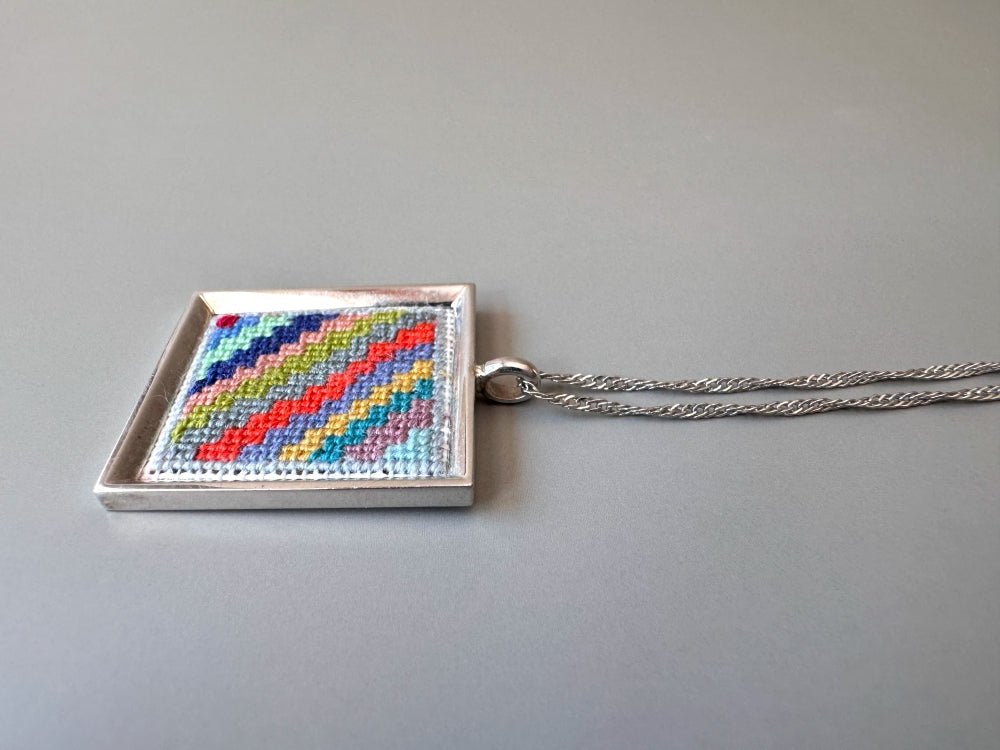 Unique hand embroidered pendant in oriental Peruvian design, set in custom silver frame - Ornamentico shop