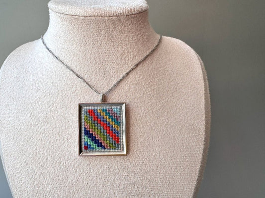 Unique hand embroidered pendant in oriental Peruvian design, set in custom silver frame - Ornamentico shop