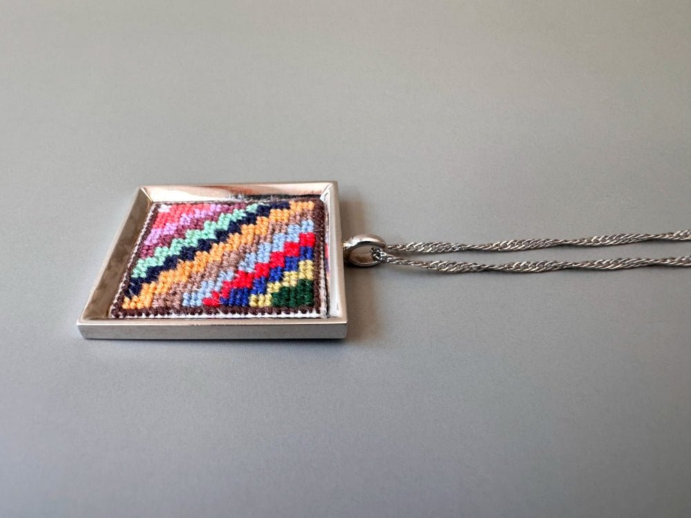 Unique hand embroidered pendant in oriental Peruvian design, set in custom silver frame - Ornamentico shop