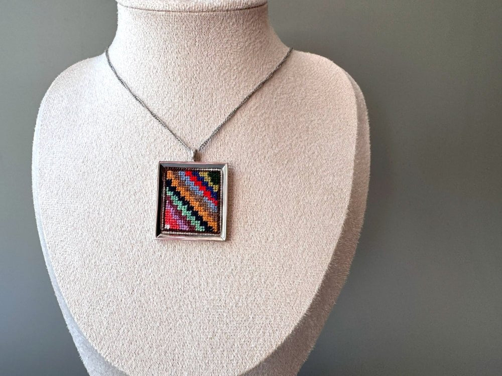 Unique hand embroidered pendant in oriental Peruvian design, set in custom silver frame - Ornamentico shop