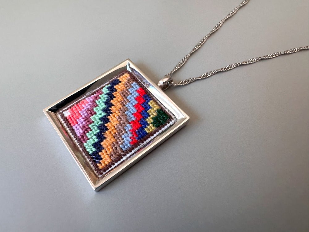 Unique hand embroidered pendant in oriental Peruvian design, set in custom silver frame - Ornamentico shop