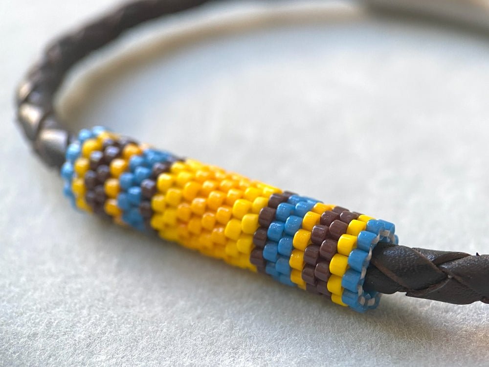 Leather bracelet from genuine brown braided leather and beaded inlay in bright orange, yellow, blue and brown colors - Ornamentico shop