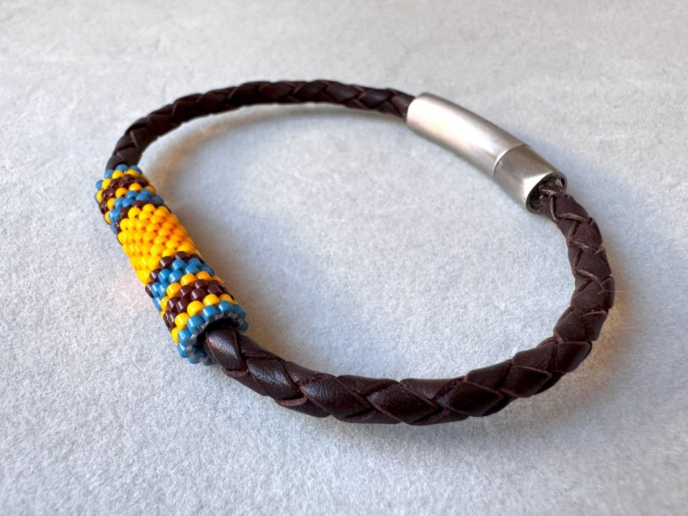 Leather bracelet from genuine brown braided leather and beaded inlay in bright orange, yellow, blue and brown colors - Ornamentico shop