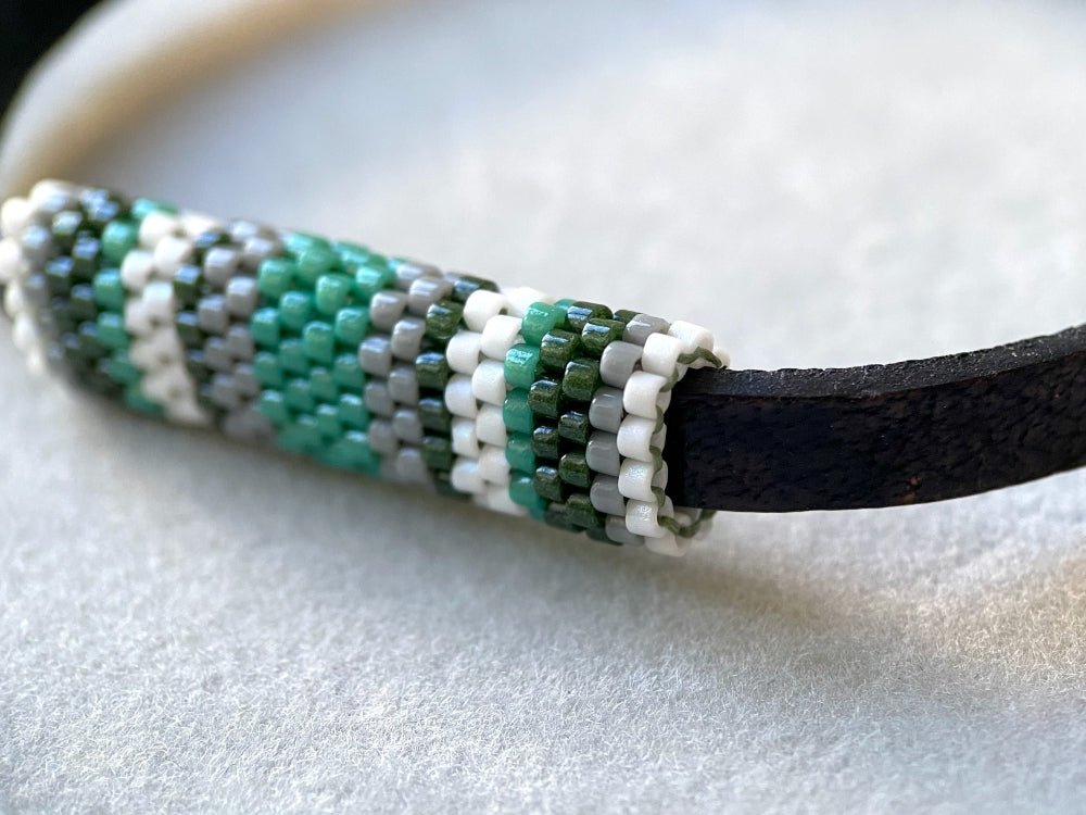Minimalistic bracelet from black genuine leather decorated with beaded inlay in green, gray and white hues - Ornamentico shop