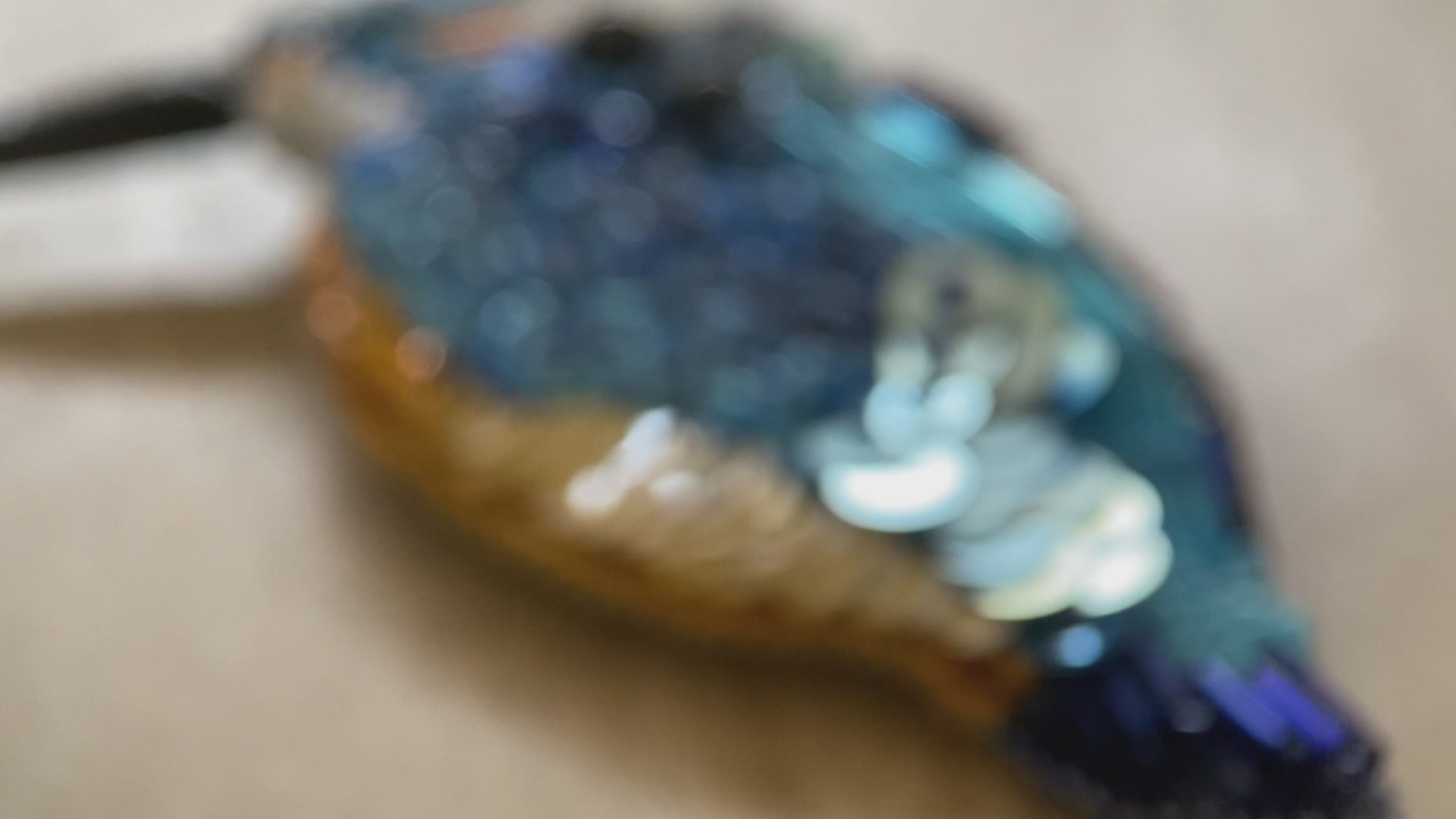 Handmade beaded brooch in the shape of a kingfisher made from glass beads, sequins, bugle beads and rhinestones