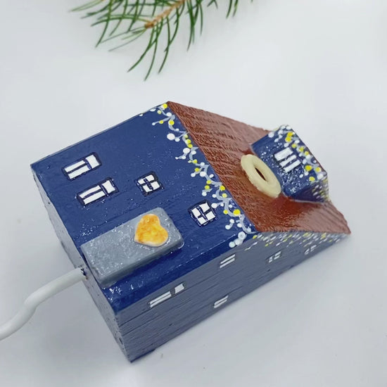 Handmade wall-mounted wooden hook in the shape of indigo blue house decorated with festive garland - Ornamentico shop