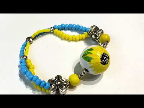 Handmade Boho style bracelet from wooden beads crafted from hand-painted wooden bead. The bracelet is decorated with beads in colors of Ukrainian flag - Ornamentico shop