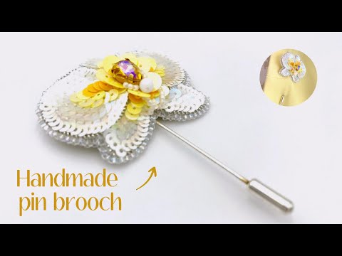 Handmade pin brooch made from rhinestone, sequins and beads in the shape of a small white orchid - Ornamentico shop