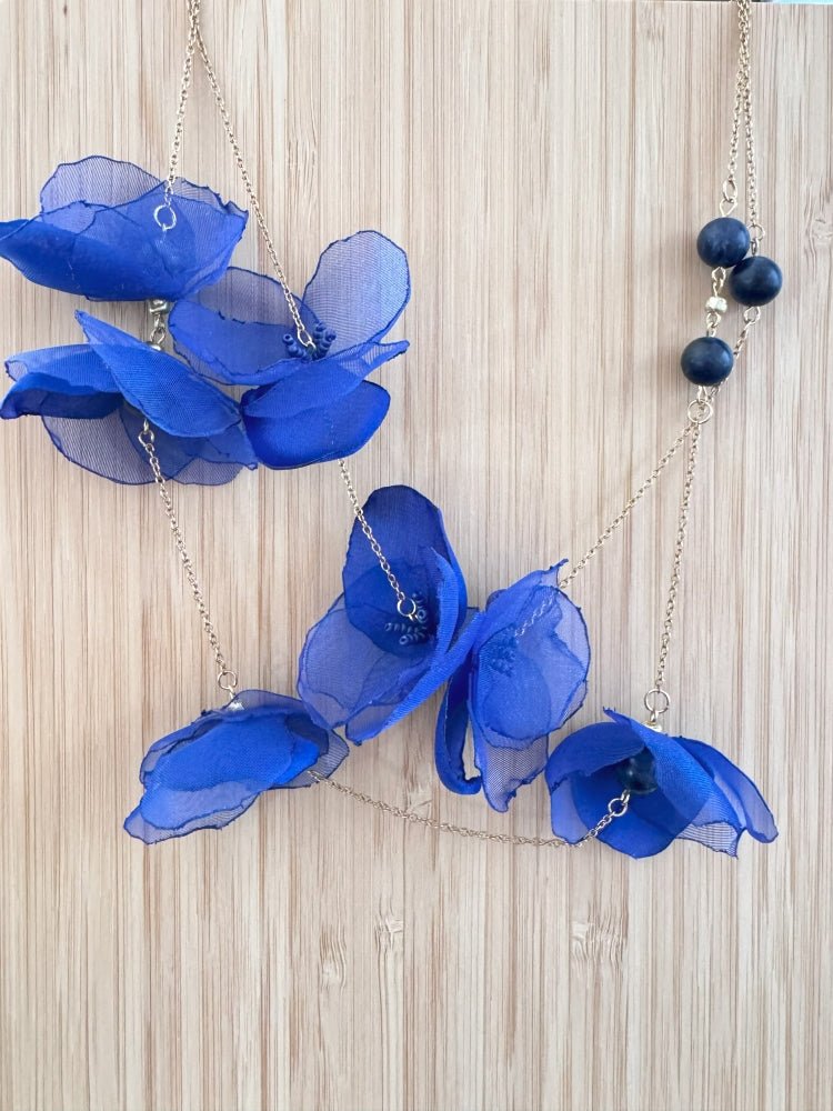 Statement floral necklace made from organza and satin flowers, beads and lapis lazuli stones