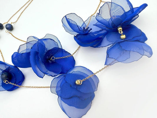 Statement floral necklace made from organza and satin flowers, beads and lapis lazuli stones