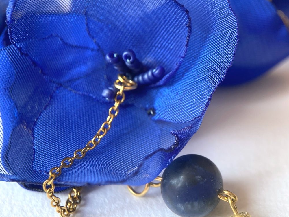 Statement floral necklace made from organza and satin flowers, beads and lapis lazuli stones