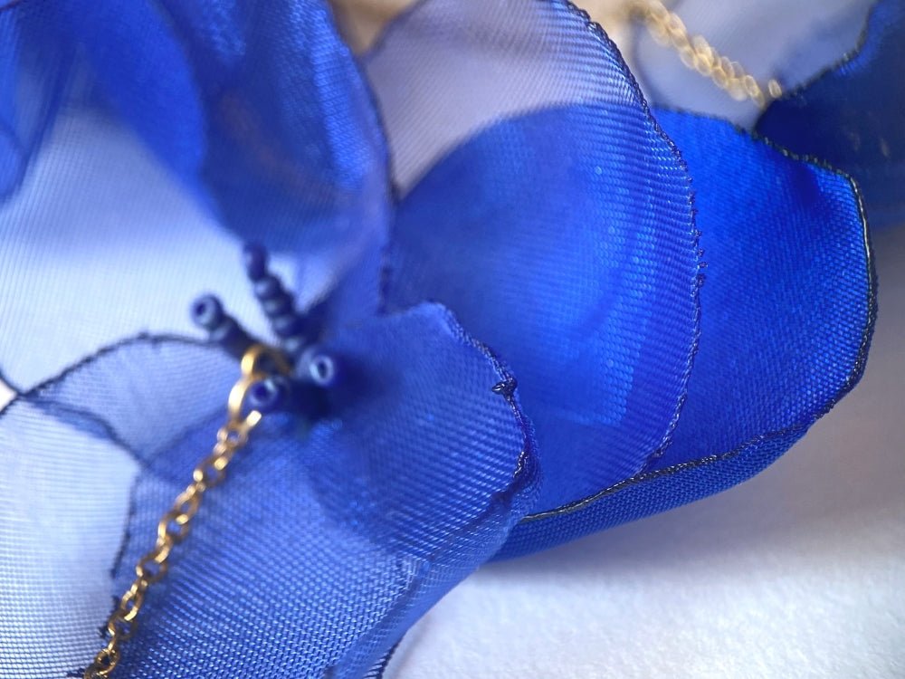 Statement floral necklace made from organza and satin flowers, beads and lapis lazuli stones