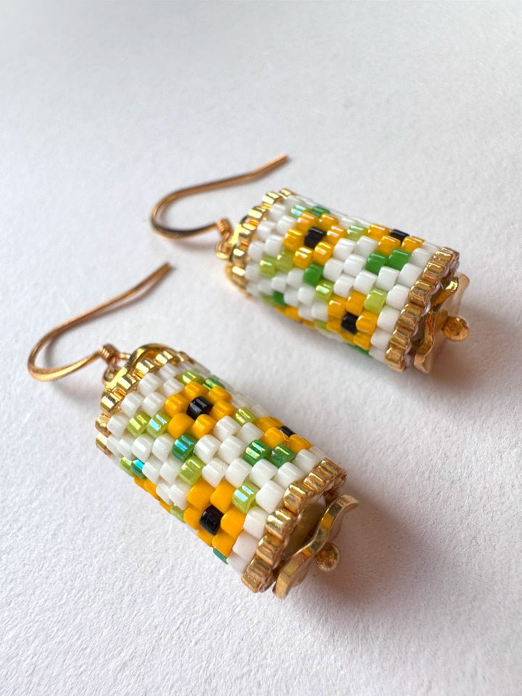 Beaded dangle earrings featuring bright sunflowers crafted in peyote stitch technique with Miyuki Delica beads