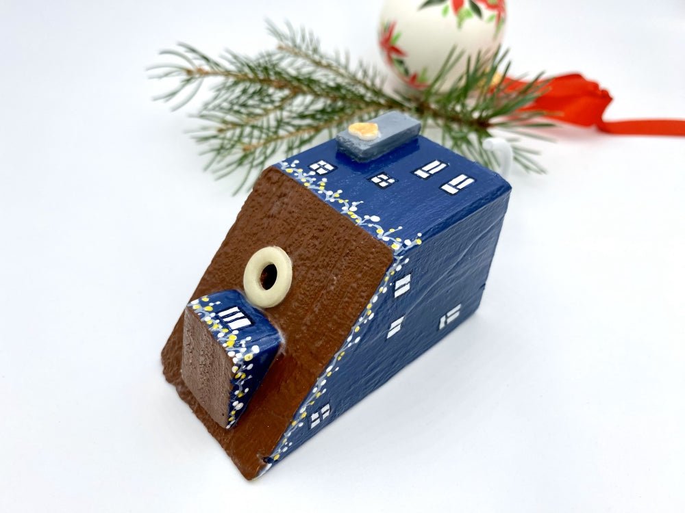 Handmade wall-mounted wooden hook in the shape of indigo blue house decorated with festive garland - Ornamentico shop