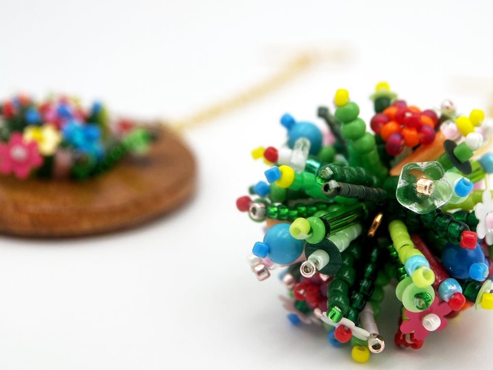 Handmade asymmetric earrings made in sculptural beading technique featuring bright floral design accented by wood - Ornamentico Group