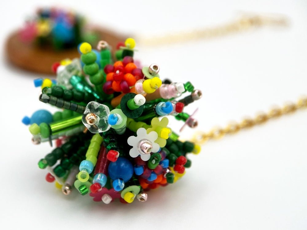 Handmade asymmetric earrings made in sculptural beading technique featuring bright floral design accented by wood - Ornamentico Group