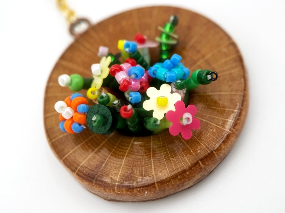 Handmade asymmetric earrings made in sculptural beading technique featuring bright floral design accented by wood - Ornamentico Group