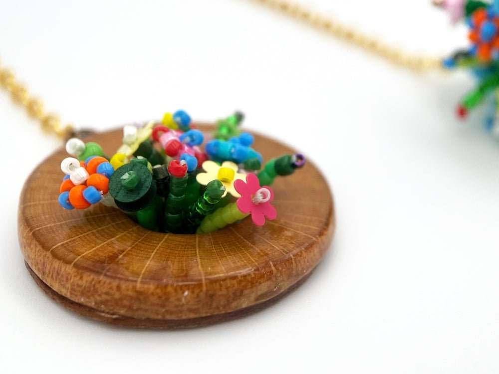 Handmade asymmetric earrings made in sculptural beading technique featuring bright floral design accented by wood - Ornamentico Group