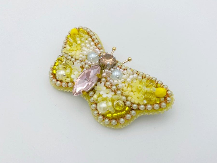 This small butterfly brooch is a handmade piece crafted in light yellow and gold colors - Ornamentico shop