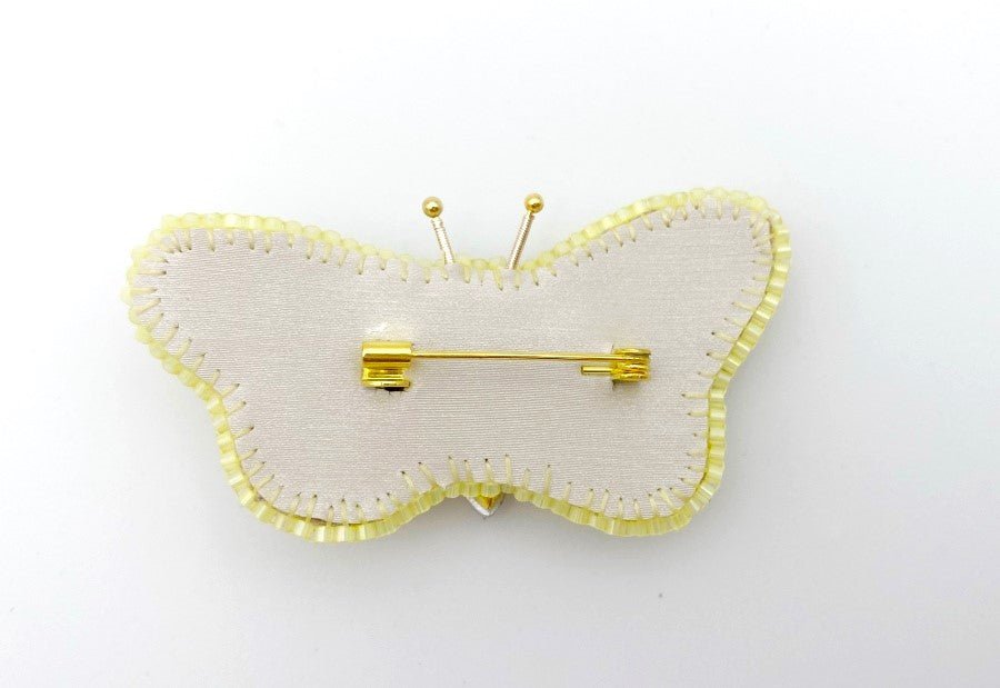This small butterfly brooch is a handmade piece crafted in light yellow and gold colors - Ornamentico shop