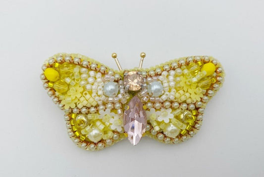 This small butterfly brooch is a handmade piece crafted in light yellow and gold colors - Ornamentico shop