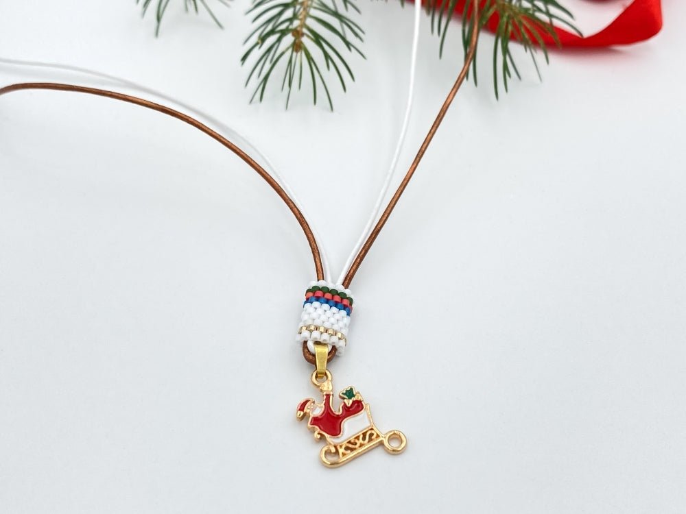 Handmade leather necklace decorated with enameled charm in the shape of Santa accented with beaded inlay - Ornamentico shop