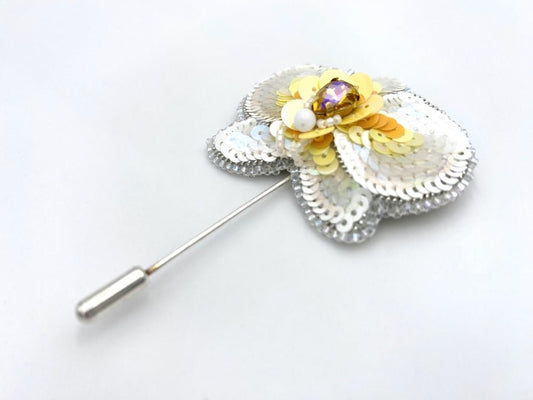 Handmade pin brooch made from rhinestone, sequins and beads in the shape of a small white orchid - Ornamentico shop
