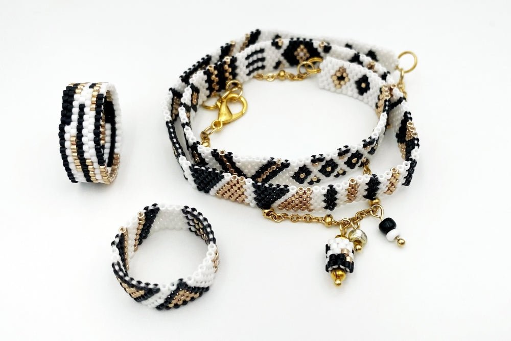 Jewelry set of bracelet and two rings made in geometrical design from black, white and gold Miyuki beads - Ornamentico shop