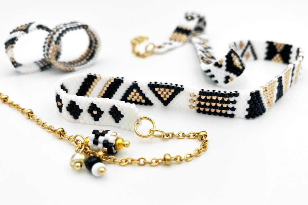 Jewelry set of bracelet and two rings made in geometrical design from black, white and gold Miyuki beads - Ornamentico shop